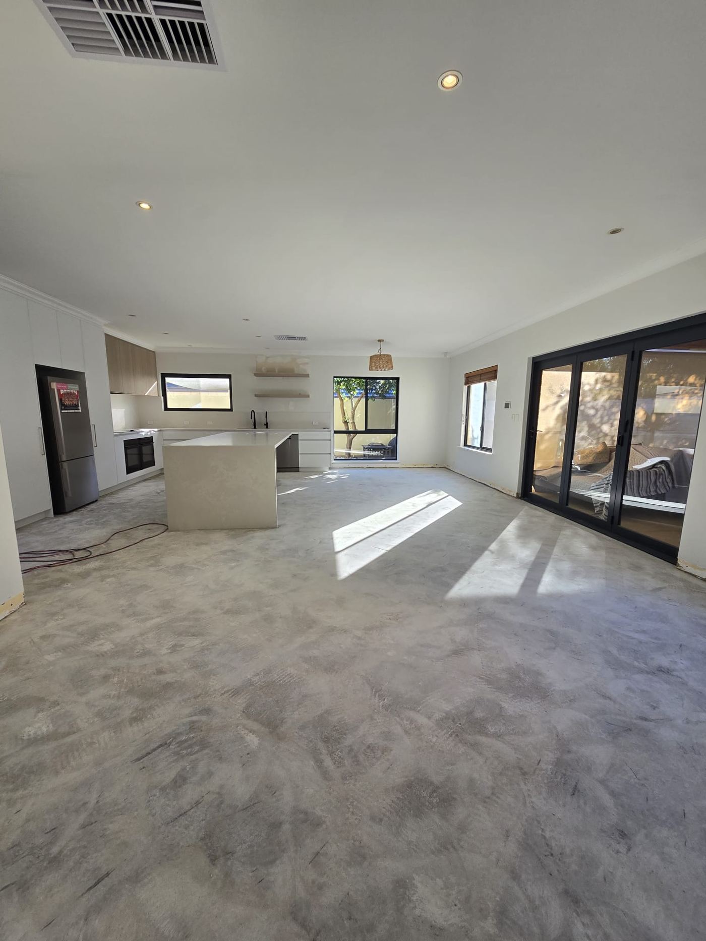 Completed open-plan living area after tile removal, Janet Street